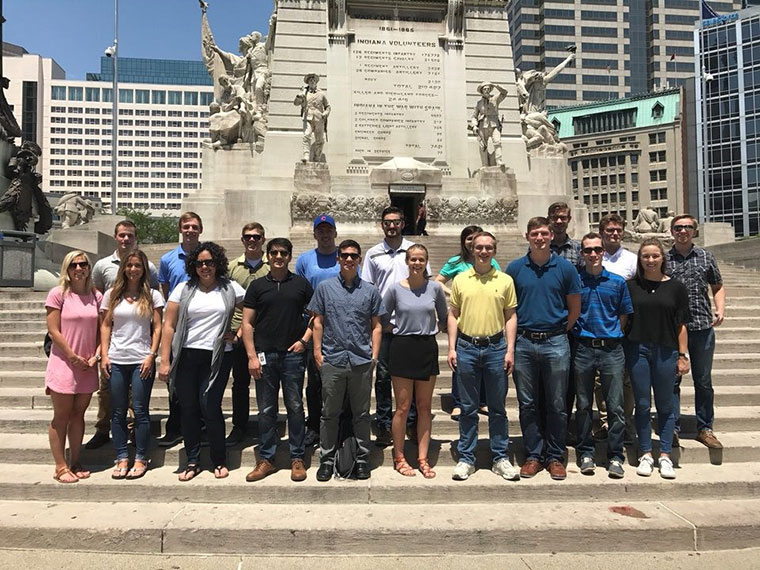Group stands infront of monument in Indianapolis